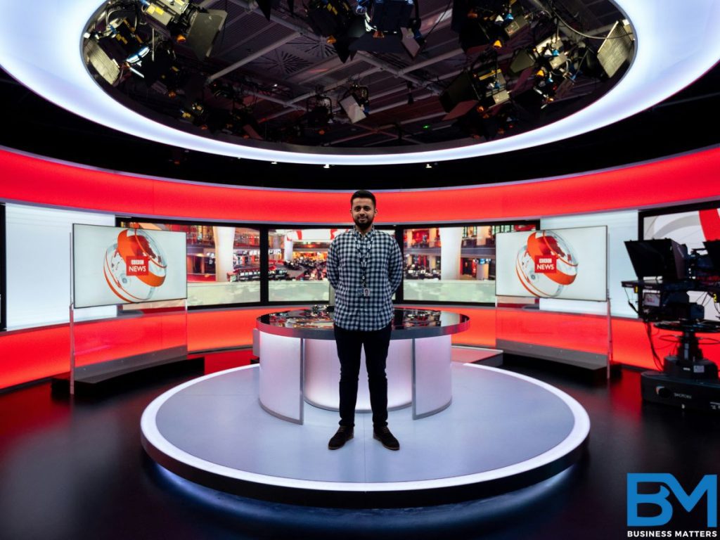 a man standing on a news channel set ready to broadcast something over news channel