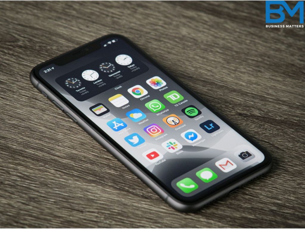 iphone 11 on a table, unlocked with icons on screen